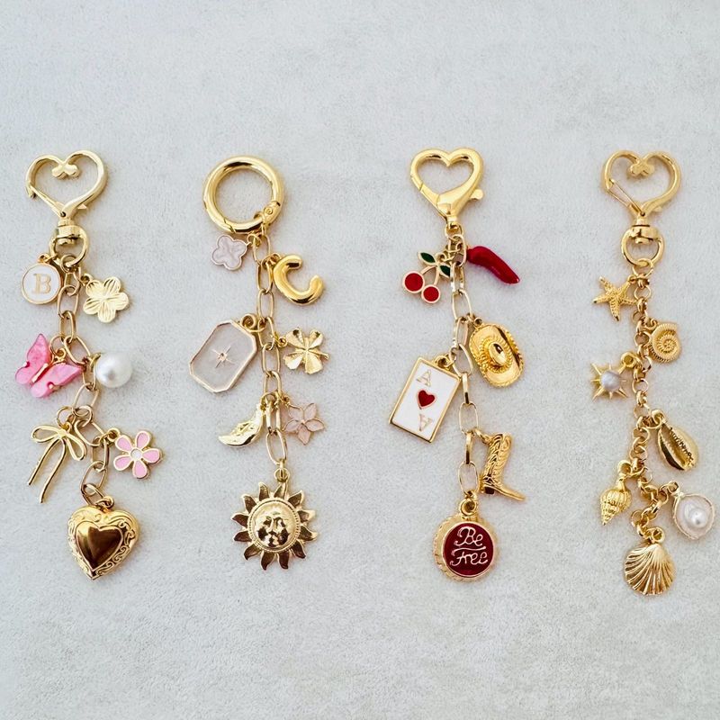 Gold bag charms with heart and ring clasps