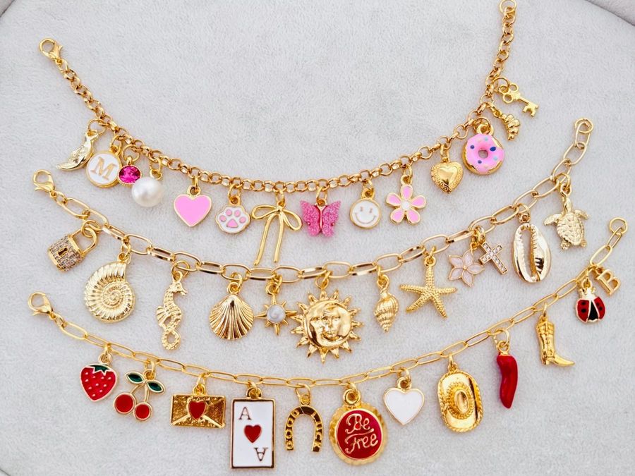 Three gold charm bracelets