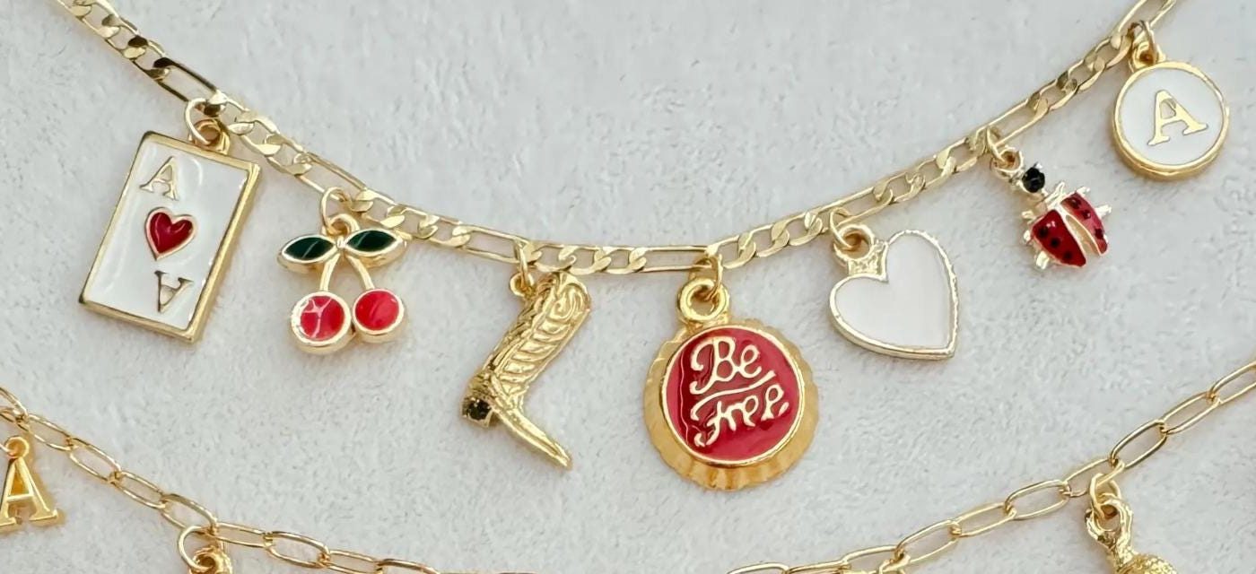 Playing card, cherry, boot and ladybug charms on a curb chain